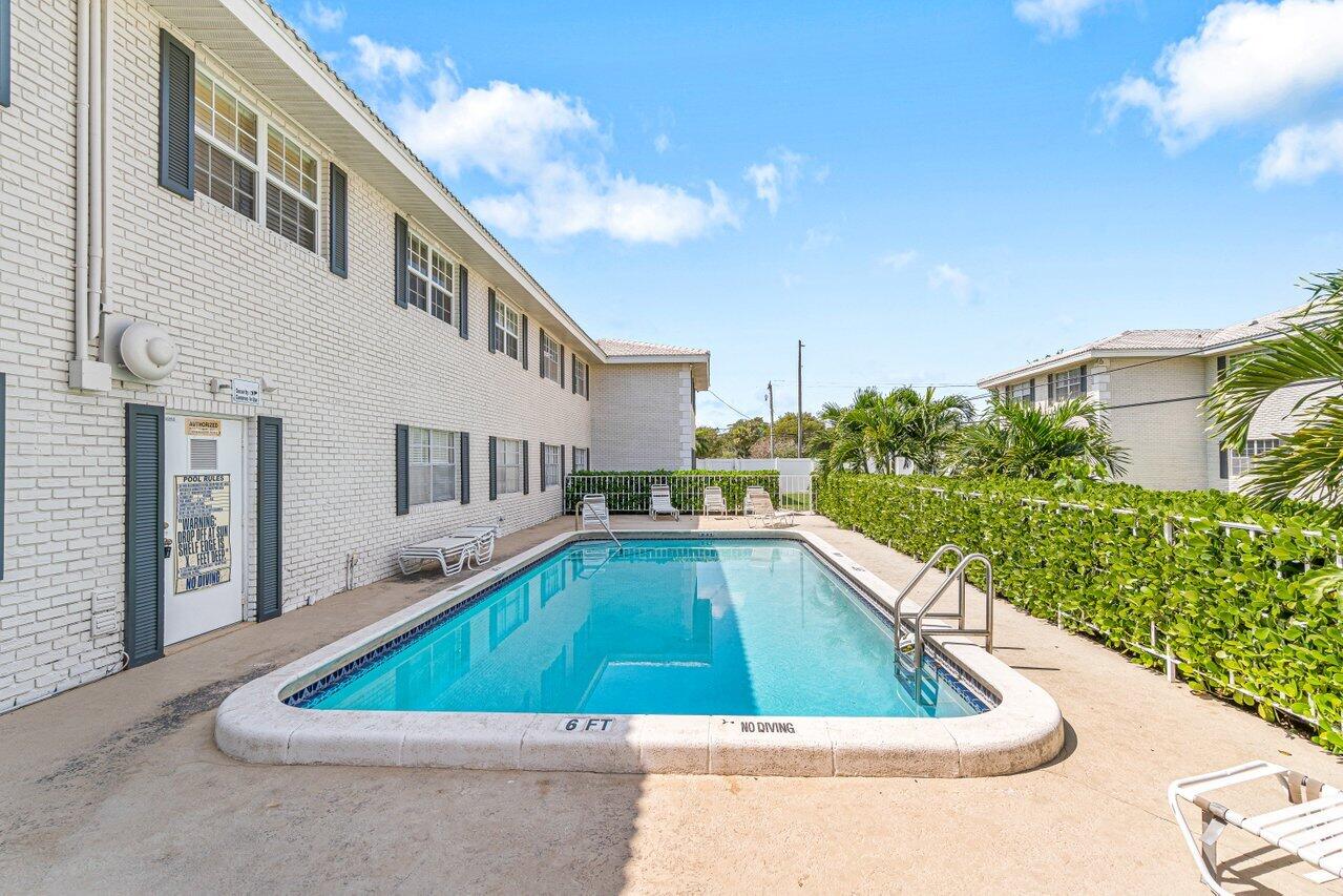299 Southwest 7th Street, Unit 2060 Boca Raton, FL 33432 - Photo 18 of 20 a view of swimming pool with outdoor seating