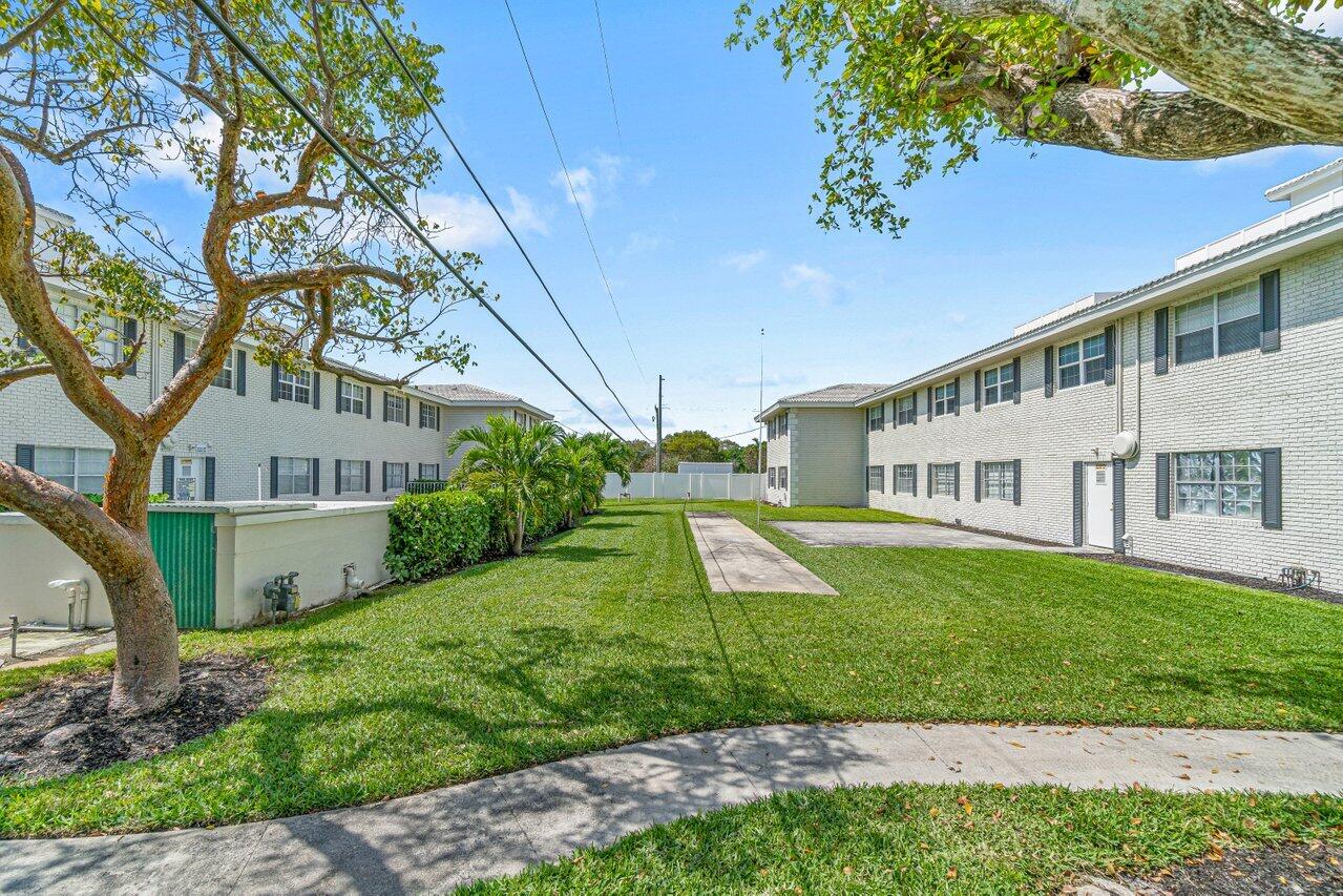 299 Southwest 7th Street, Unit 2060 Boca Raton, FL 33432 - Photo 20 of 20 a view of a house with a yard