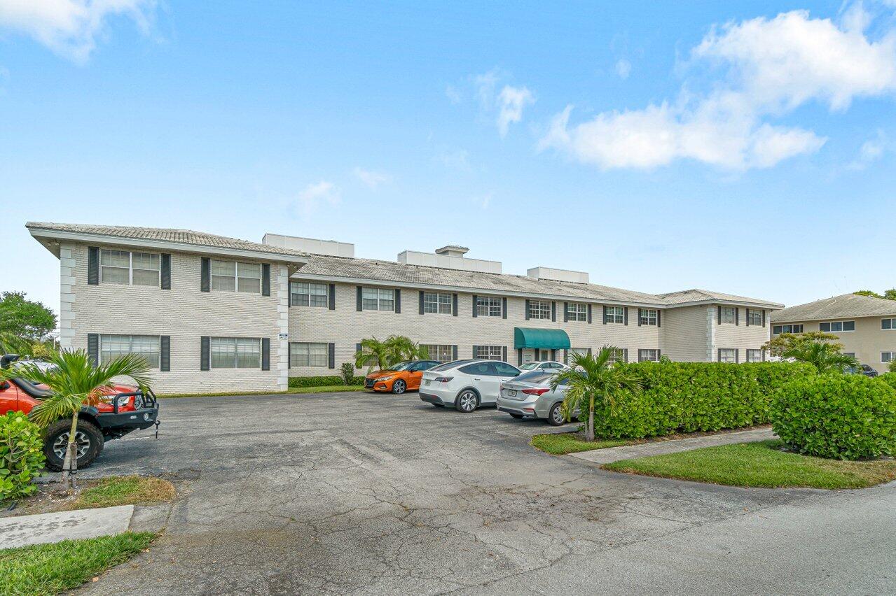 299 Southwest 7th Street, Unit 2060 Boca Raton, FL 33432 - Photo 2 of 20 a front view of building with cars parked
