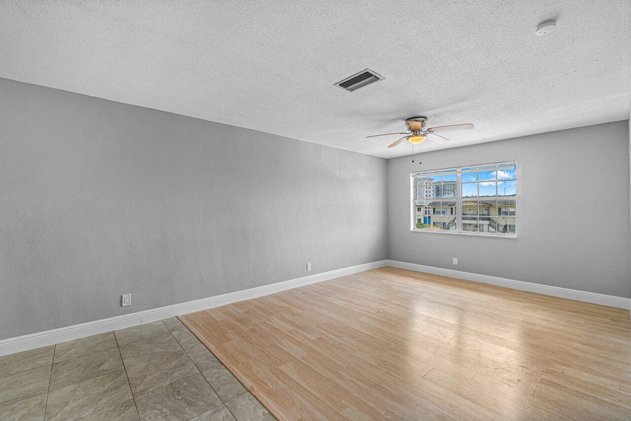 299 Southwest 7th Street, Unit 2060 Boca Raton, FL 33432 - Photo 9 of 20 an empty room with windows