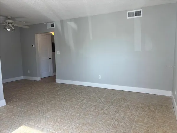 a kitchen with granite countertop a stove a sink and a refrigerator