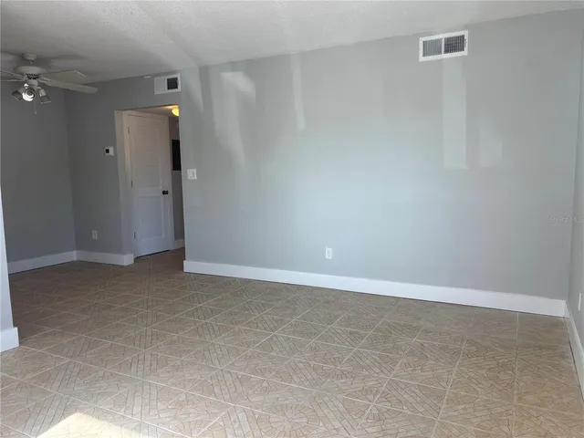 a kitchen with granite countertop a stove a sink and a refrigerator