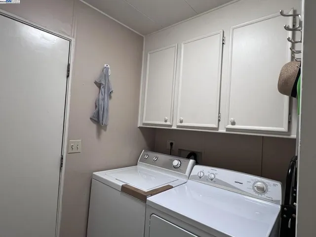a view of bathroom with a sink dryer and washer