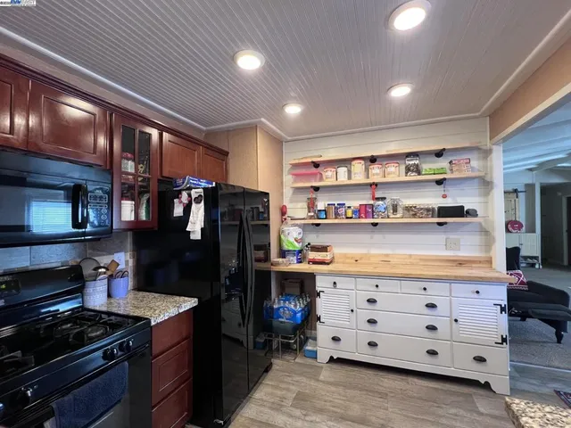 a kitchen with stainless steel appliances a refrigerator and a stove