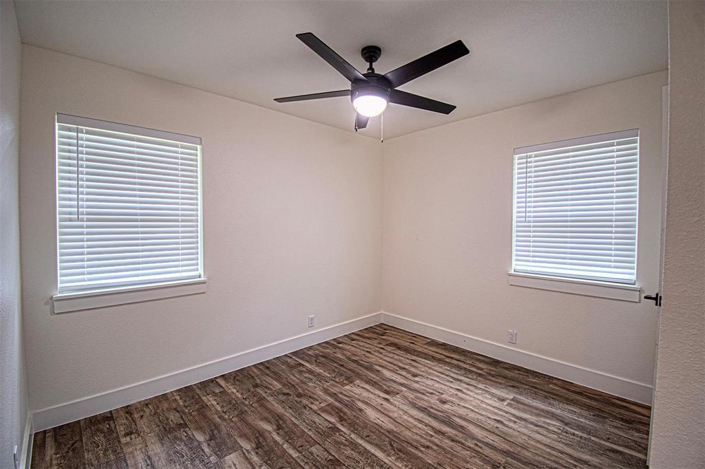 551 East Burks Street Pilot Point, TX 76258 - Photo 15 of 29 a view of empty room with wooden floor and fan