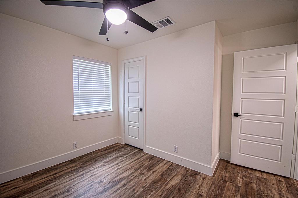 551 East Burks Street Pilot Point, TX 76258 - Photo 16 of 29 a view of empty room with wooden floor and fan