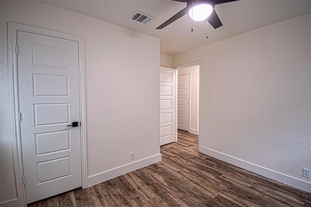 551 East Burks Street Pilot Point, TX 76258 - Photo 17 of 29 an empty room with wooden floor cabinet and windows