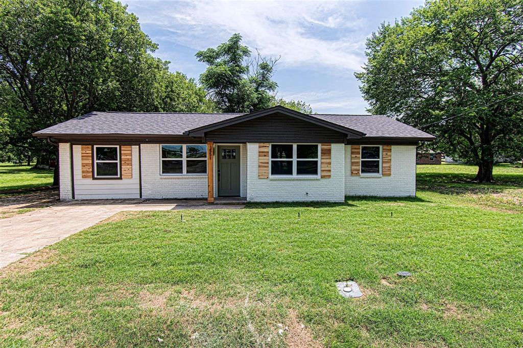 551 East Burks Street Pilot Point, TX 76258 - Photo 2 of 29 a front view of a house with a garden