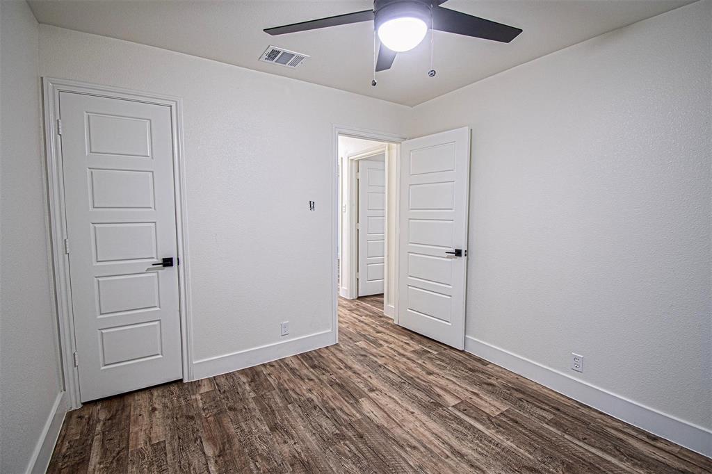 551 East Burks Street Pilot Point, TX 76258 - Photo 26 of 29 an empty room with wooden floor closet and chandelier fan