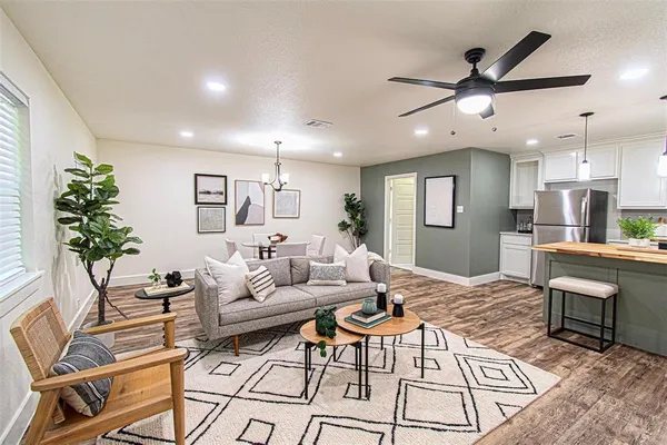 a living room with furniture and a wooden floor