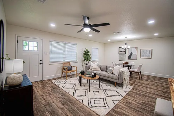 a living room with furniture and a chandelier