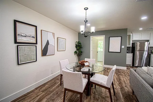 a view of a dining room with furniture and chandelier