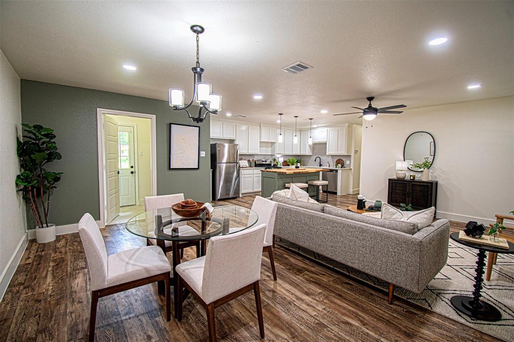 551 East Burks Street Pilot Point, TX 76258 - Photo 8 of 29 a living room with furniture kitchen view and a chandelier