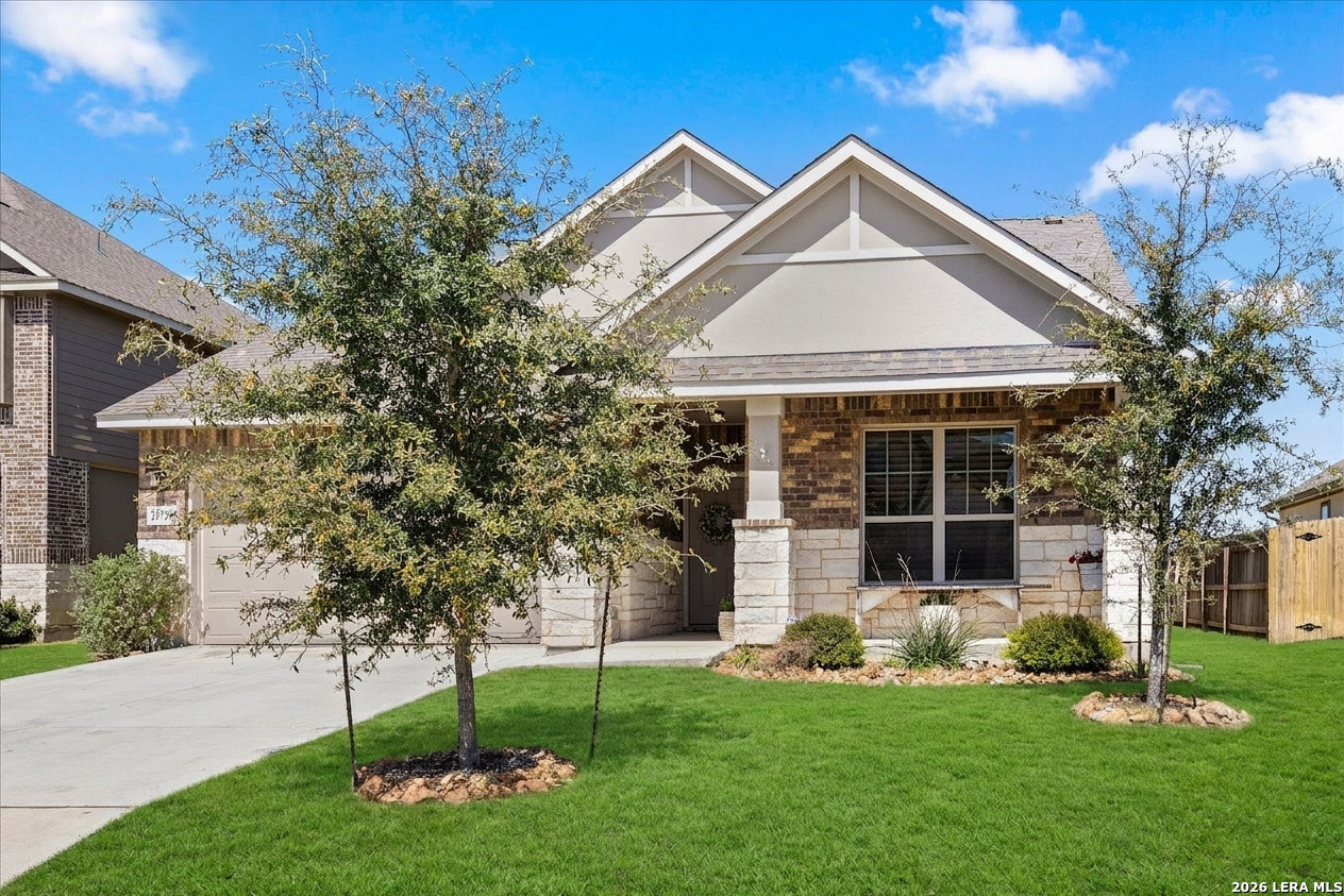 29739 Elkhorn Ridge Fair Oaks Ranch, TX 78015 - Photo 2 of 47 a front view of a house with a garden and trees