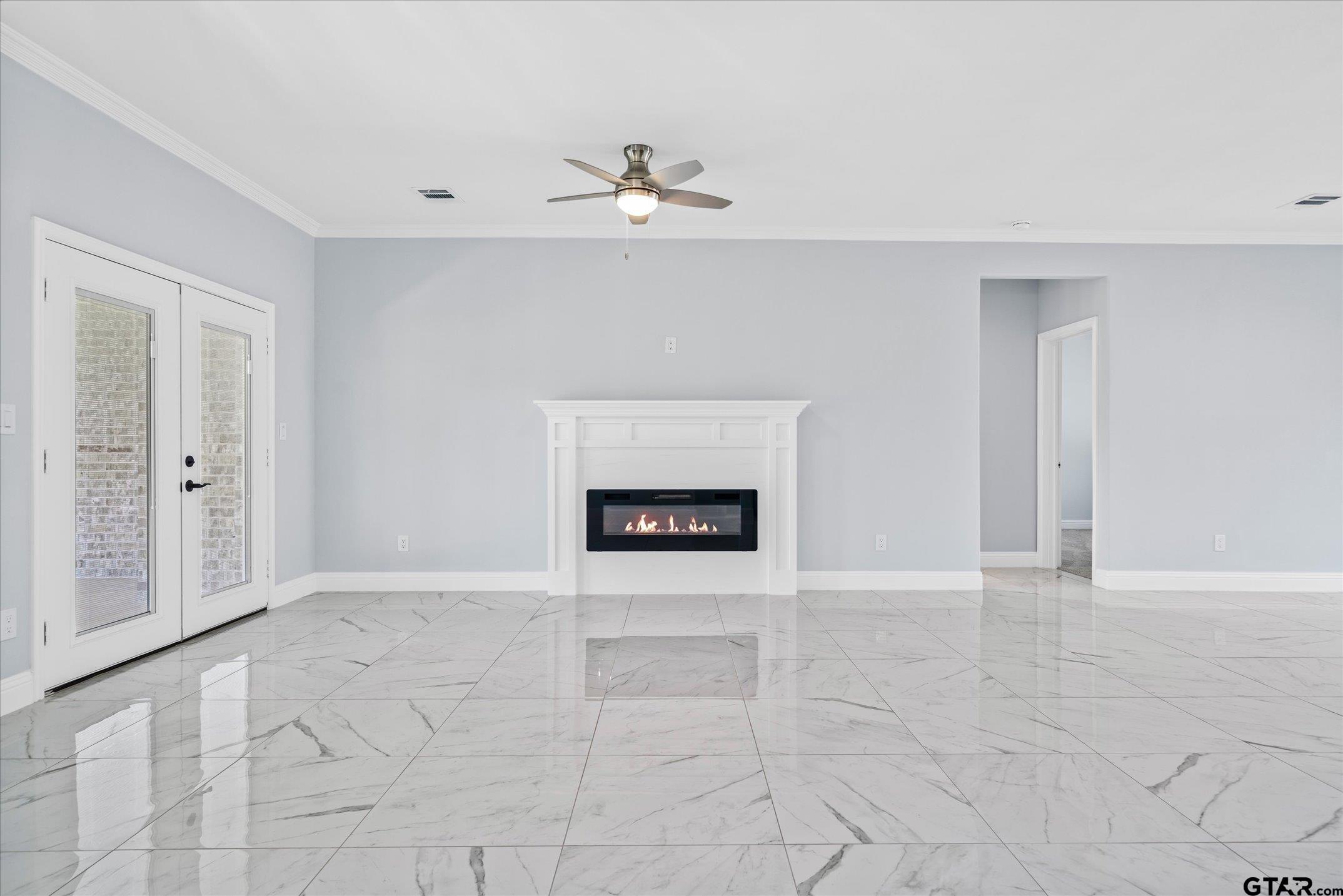 581 Imagine Drive Lindale, TX 75771 - Photo 16 of 35 an empty room with windows and fireplace