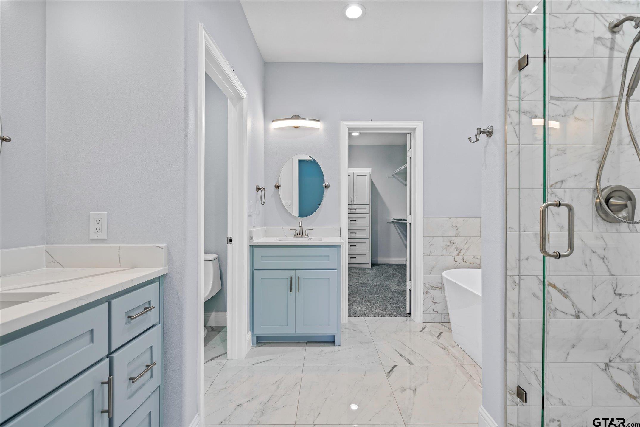 581 Imagine Drive Lindale, TX 75771 - Photo 18 of 35 a spacious bathroom with a granite countertop sink mirror and shower