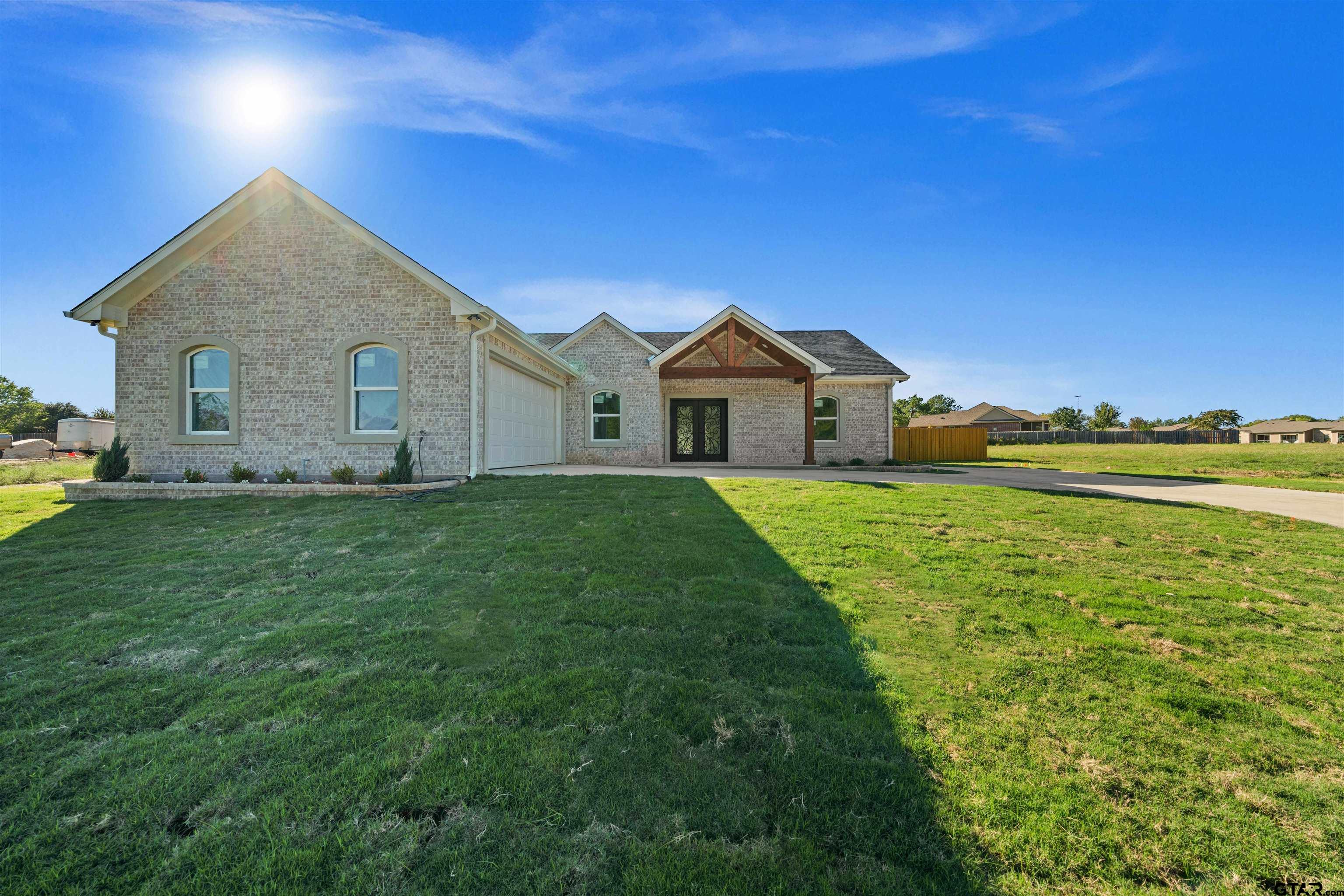 581 Imagine Drive Lindale, TX 75771 - Photo 2 of 35 a front view of a house with garden