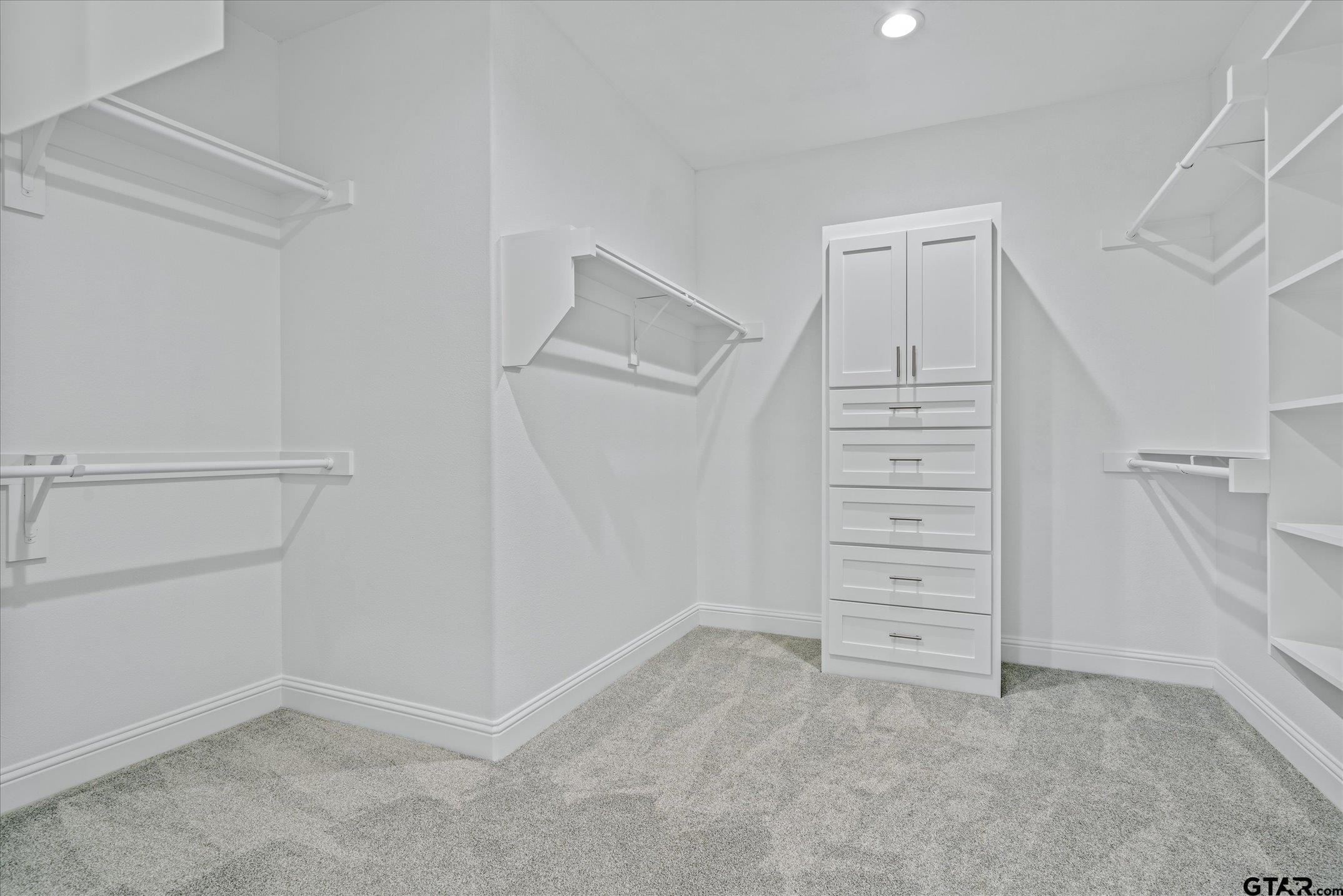 581 Imagine Drive Lindale, TX 75771 - Photo 21 of 35 wooden view of walk in closet with empty racks