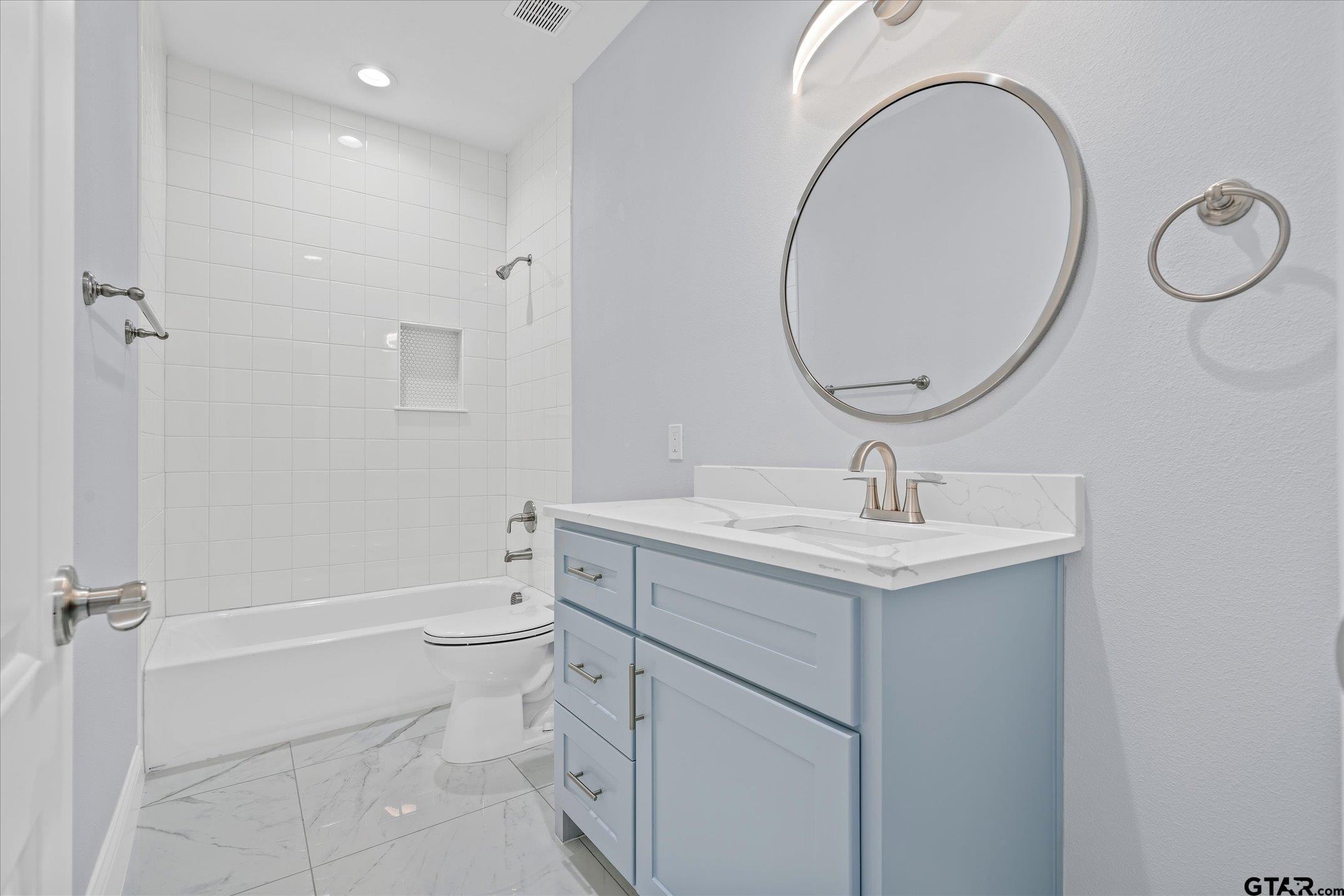 581 Imagine Drive Lindale, TX 75771 - Photo 25 of 35 a bathroom with a sink a toilet and a mirror