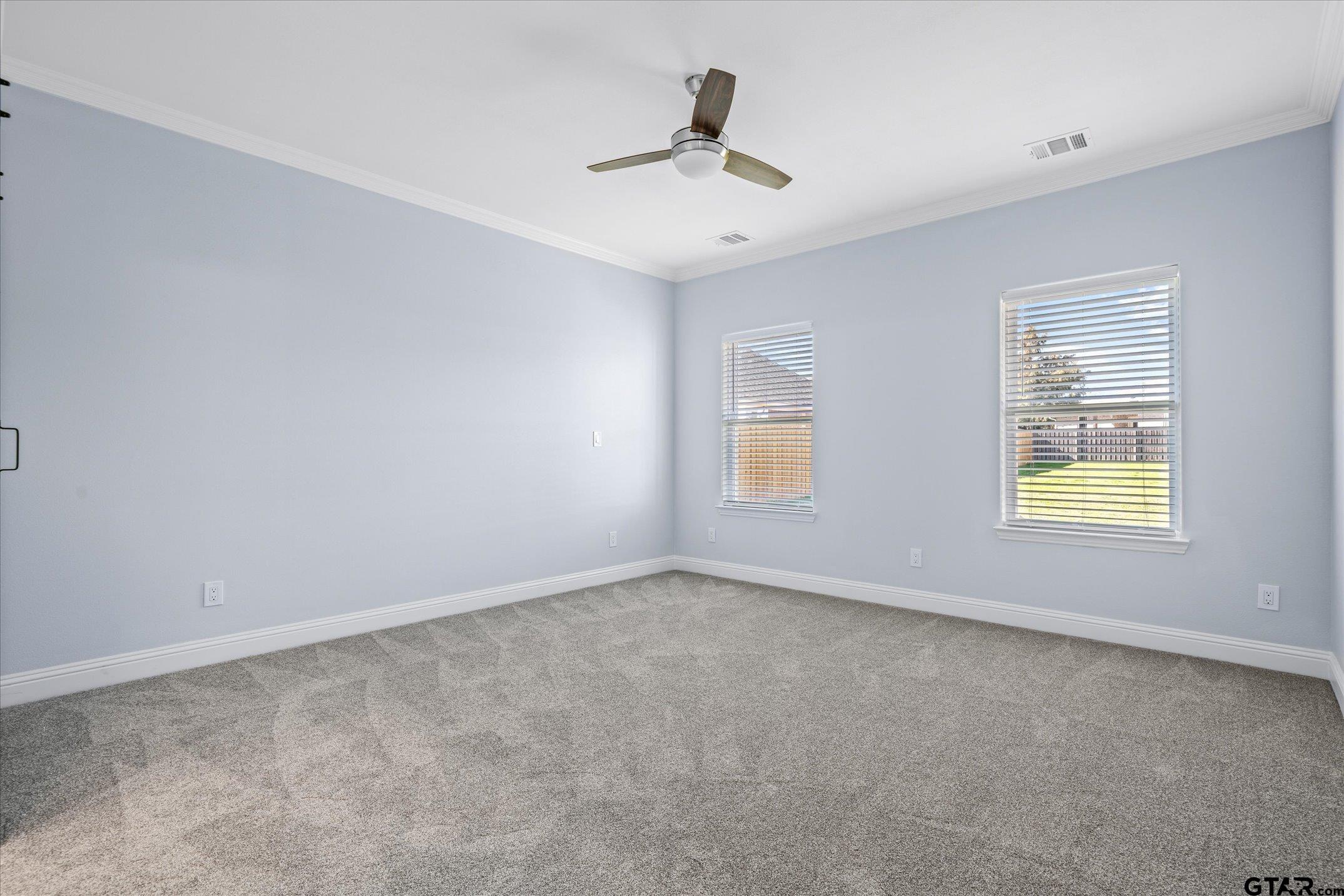 581 Imagine Drive Lindale, TX 75771 - Photo 28 of 35 an empty room with windows and ceiling fan
