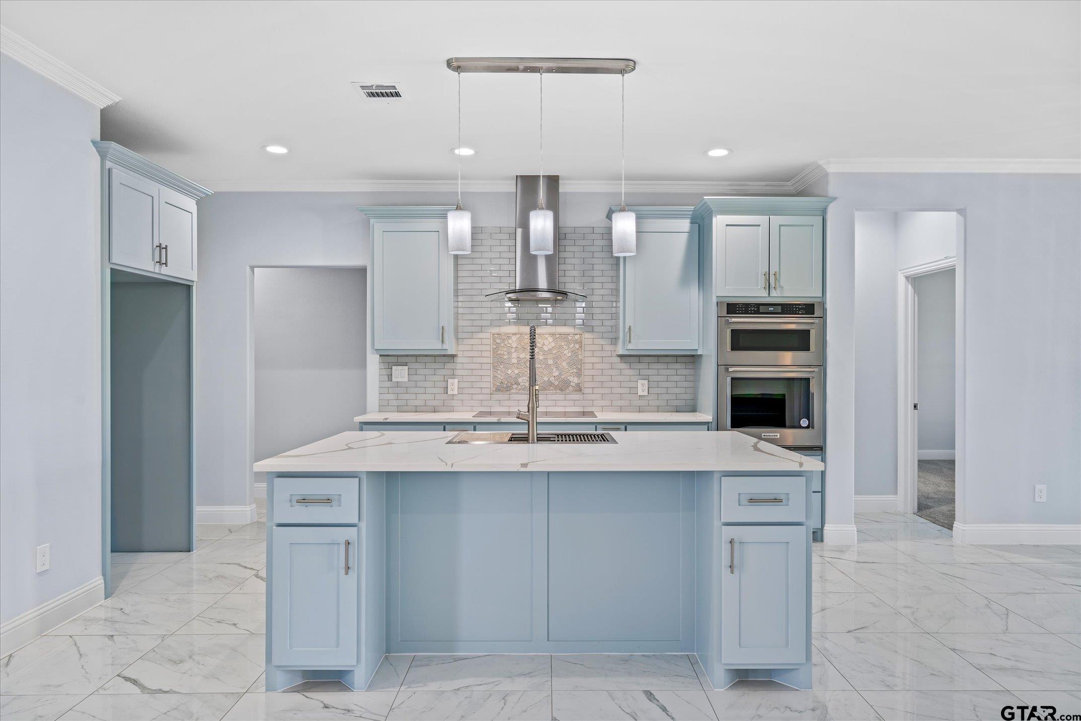 581 Imagine Drive Lindale, TX 75771 - Photo 9 of 35 a kitchen with kitchen island a sink stainless steel appliances and cabinets