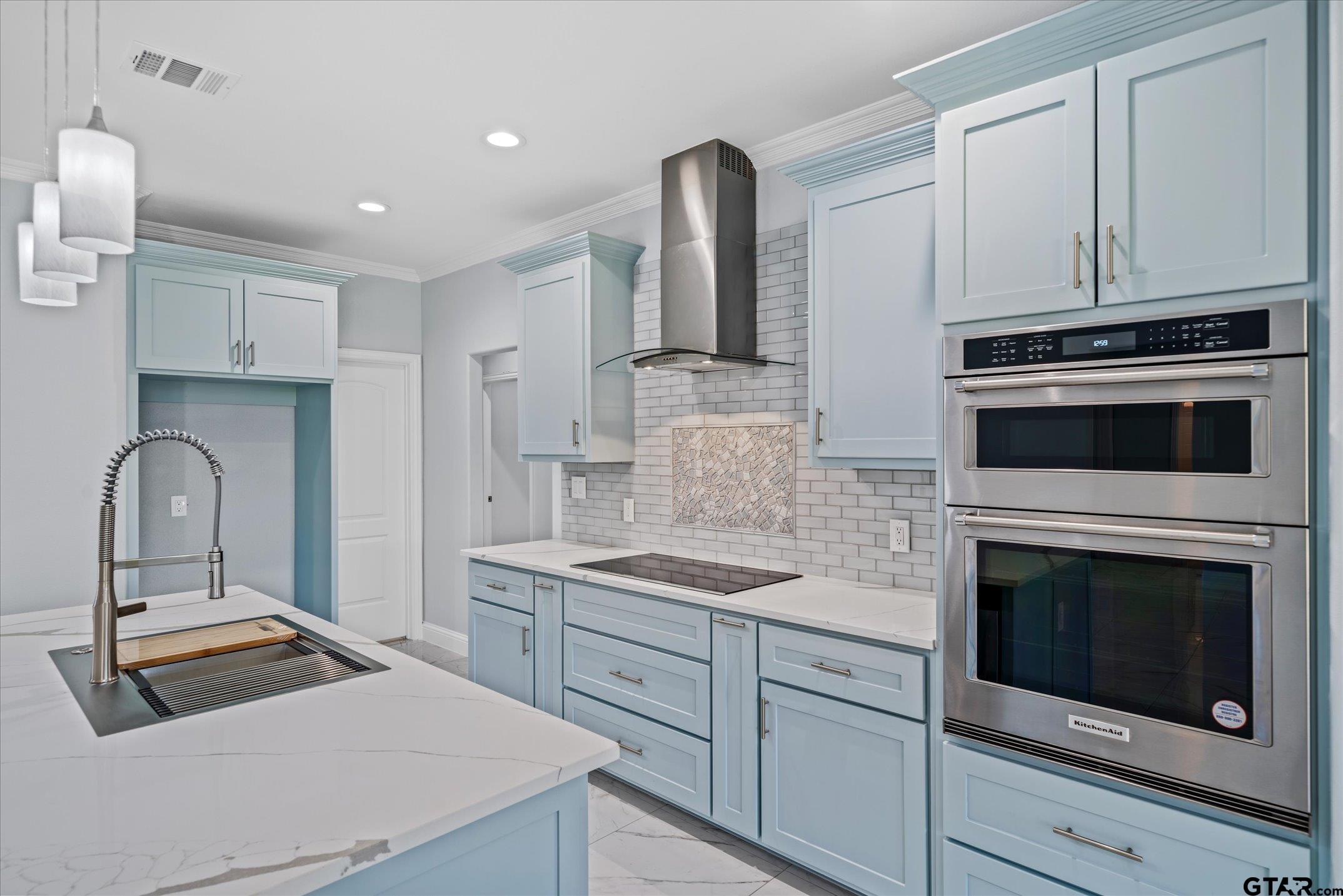 581 Imagine Drive Lindale, TX 75771 - Photo 10 of 35 a kitchen with stainless steel appliances a stove microwave and sink