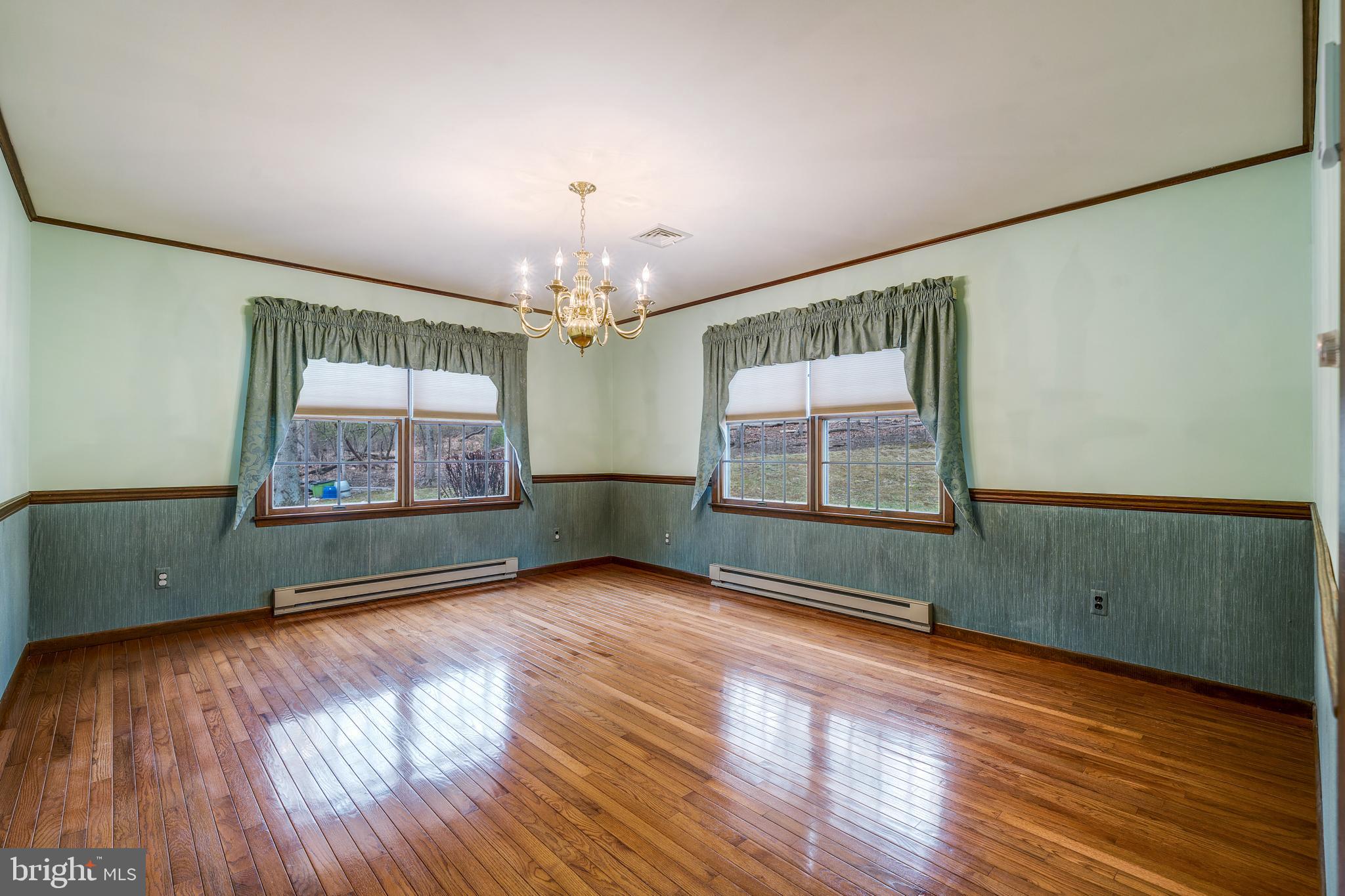 169 East Mountain Road Hillsborough, NJ 08844 - Photo 13 of 29 an empty room with wooden floor chandelier and windows