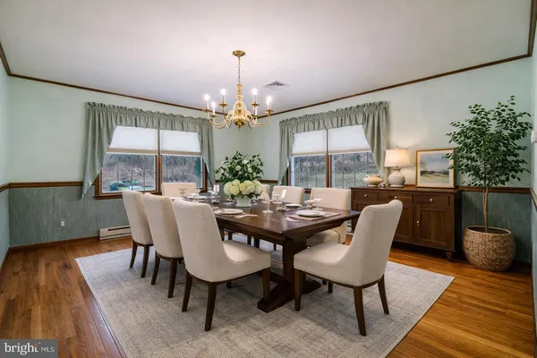 a view of a dining room with furniture window and wooden floor