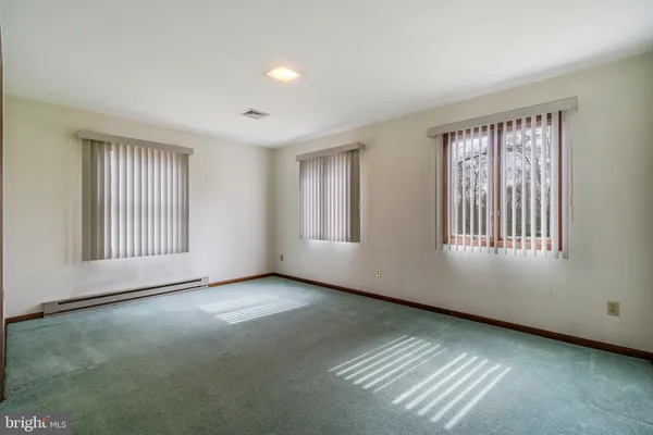 a view of an empty room with windows