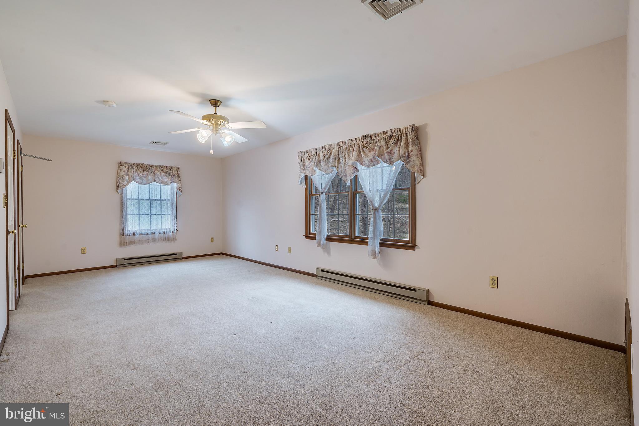 169 East Mountain Road Hillsborough, NJ 08844 - Photo 20 of 29 an empty room with windows and ceiling fan view