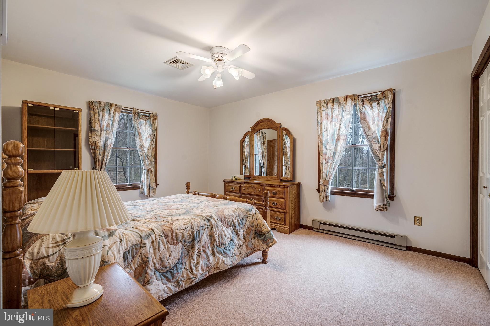169 East Mountain Road Hillsborough, NJ 08844 - Photo 21 of 29 a bedroom with a large bed and windows