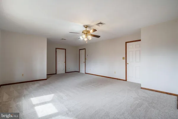 a view of a room with a ceiling fan and a chandelier fan