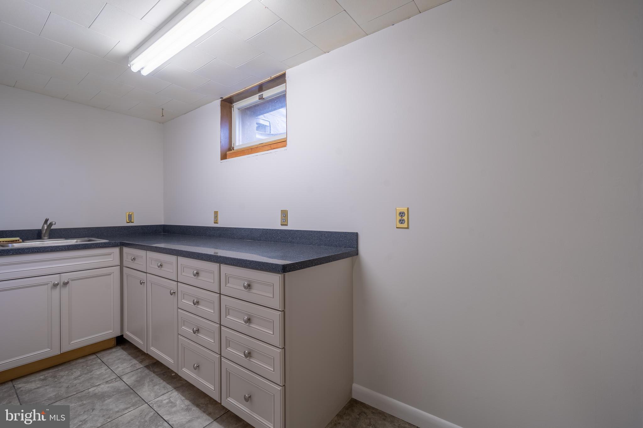 169 East Mountain Road Hillsborough, NJ 08844 - Photo 27 of 29 a view of cabinets a sink wooden floor and a window in a room