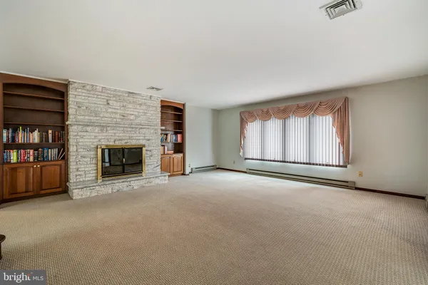a view of empty room with a fireplace