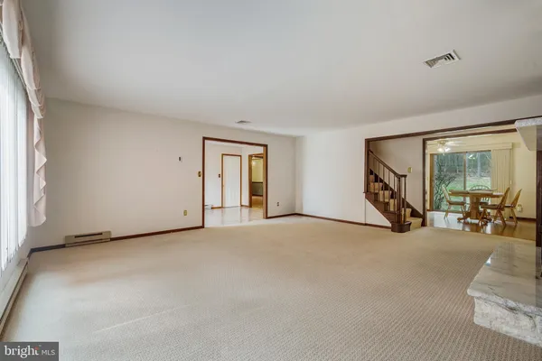 a view of a livingroom with glass door and furniture
