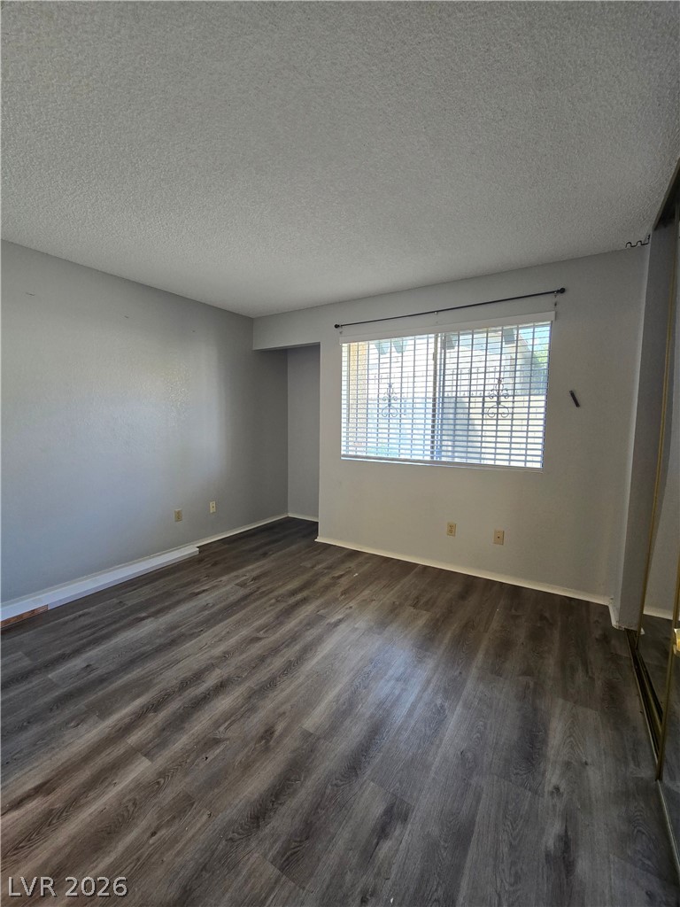 6750 Del Rey Avenue, Unit 133 Las Vegas, NV 89146 - Photo 17 of 34 Laminate flooring graces this naturally illuminated room, offering a versatile blank canvas.