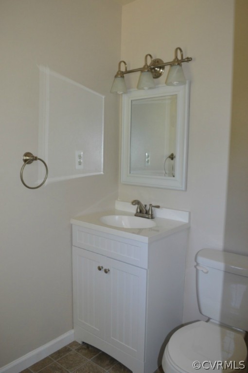 3650 Hemlock Road Chester, VA 23831 - Photo 7 of 12 a bathroom with a granite countertop toilet sink and mirror