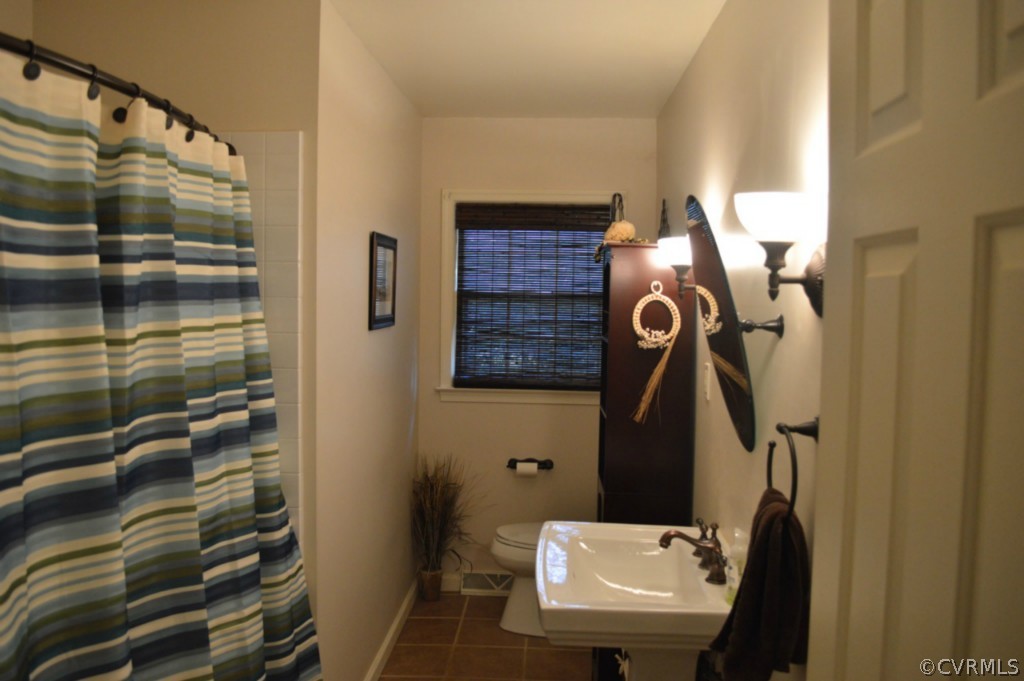 3650 Hemlock Road Chester, VA 23831 - Photo 10 of 12 a bathroom with a sink and mirror with toilet