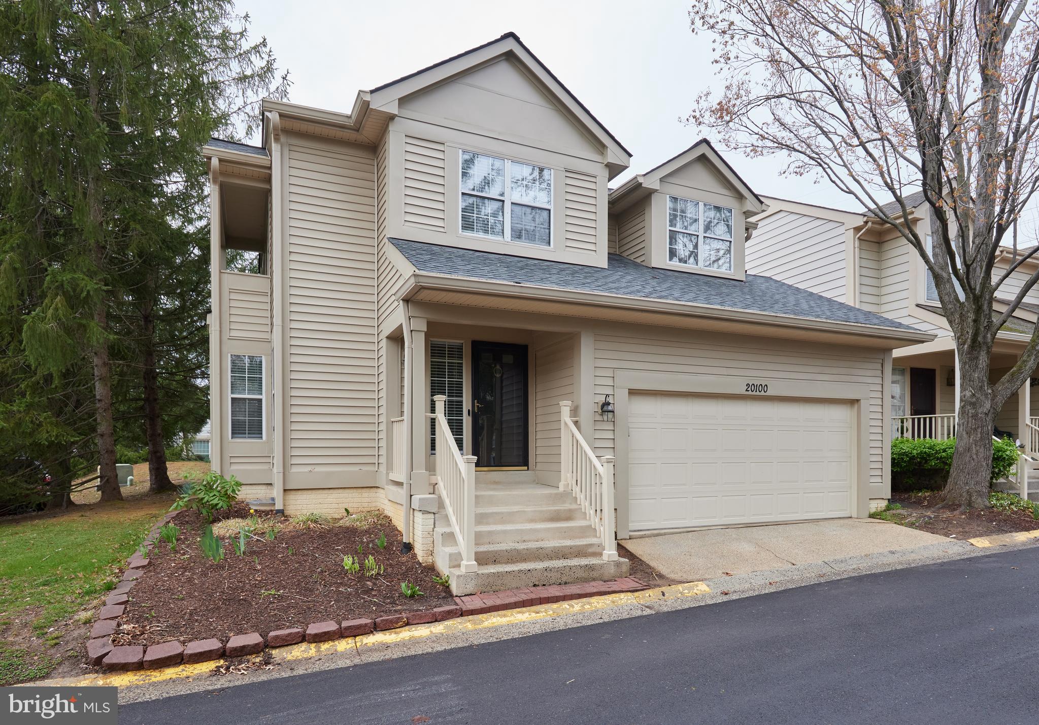 20100 Loading Rock Place Gaithersburg, MD 20886 - Photo 1 of 44 a front view of a house with a garage