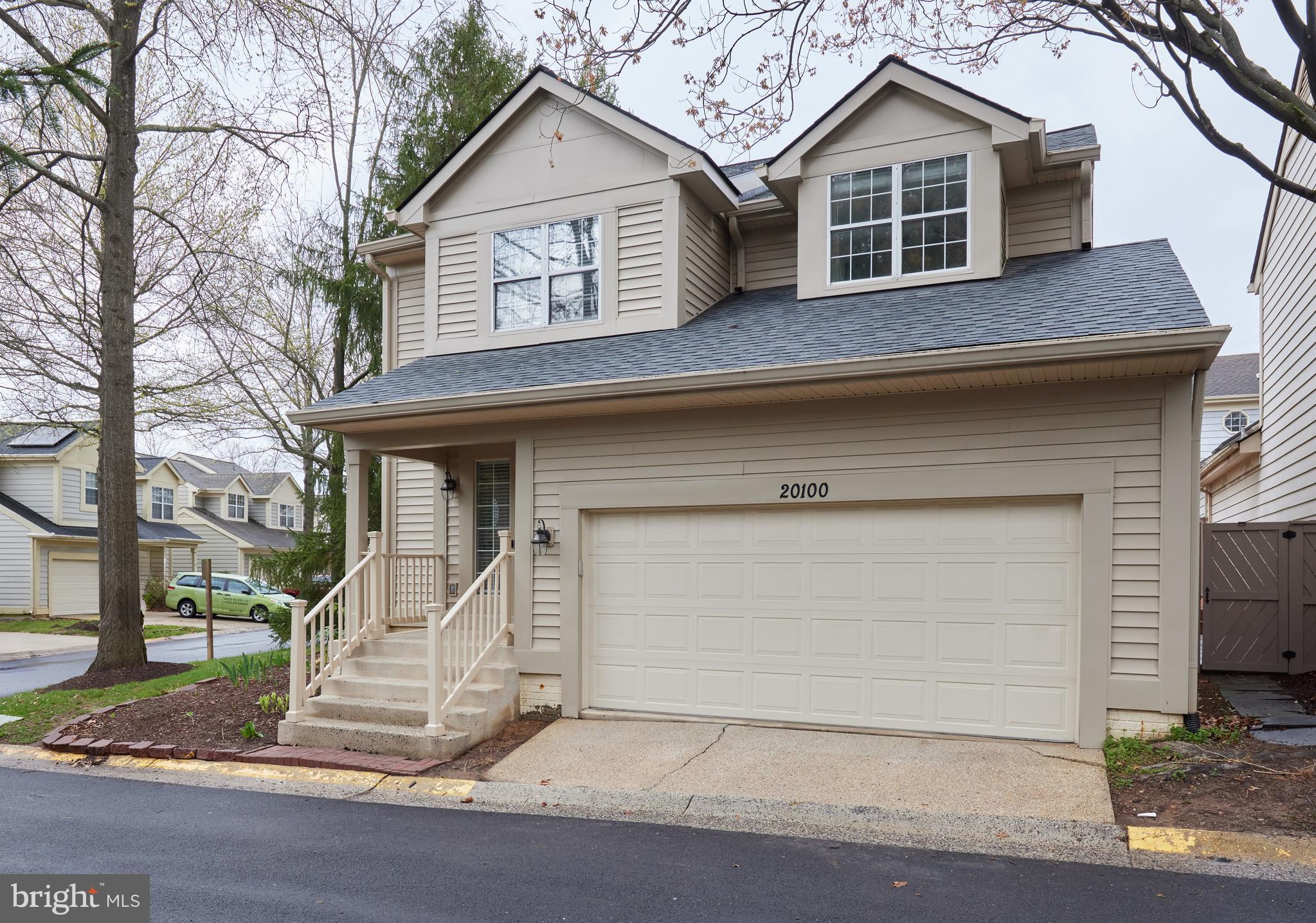 20100 Loading Rock Place Gaithersburg, MD 20886 - Photo 2 of 44 a front view of a house with a yard