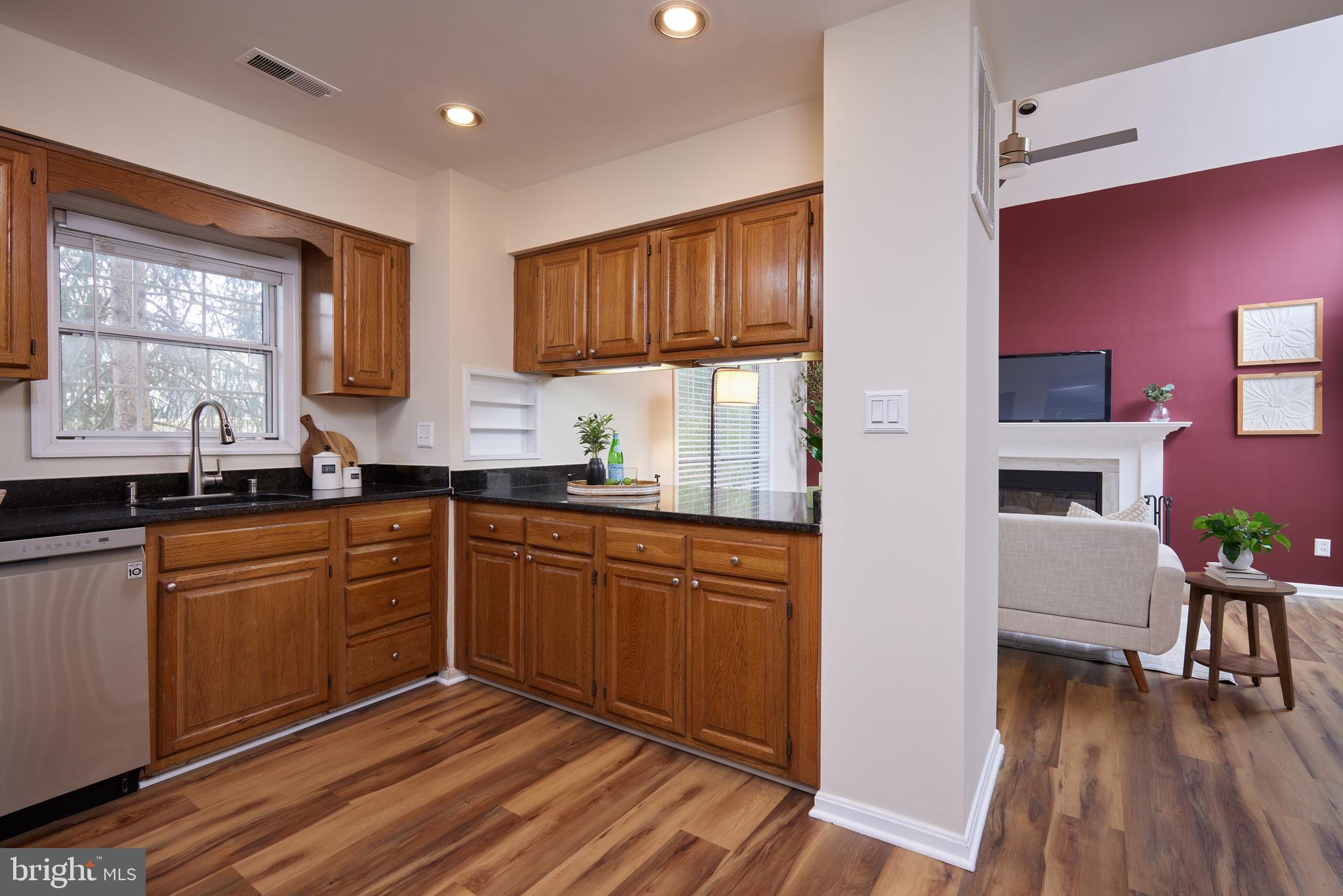 20100 Loading Rock Place Gaithersburg, MD 20886 - Photo 21 of 44 a kitchen with granite countertop a sink cabinets and wooden floor