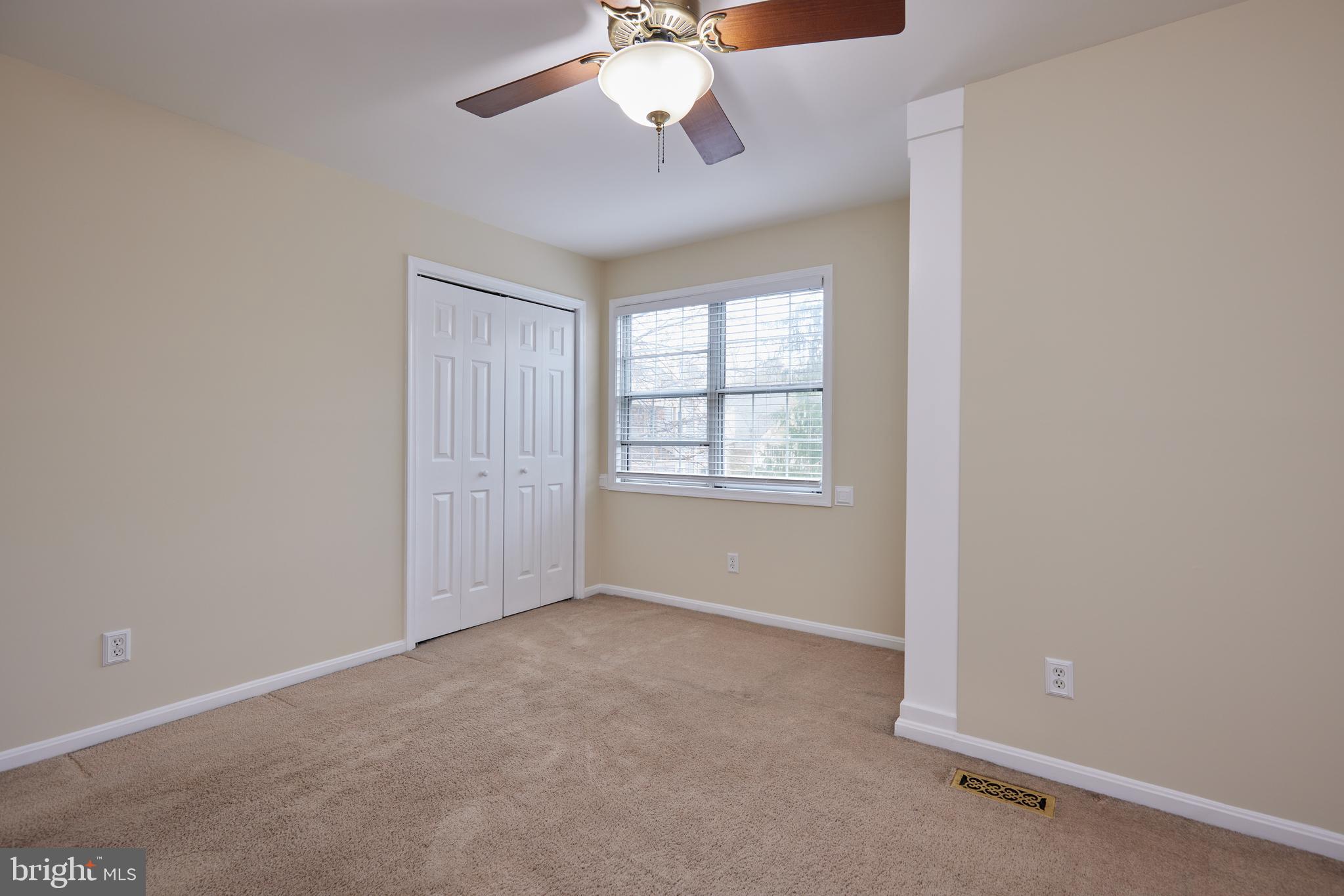20100 Loading Rock Place Gaithersburg, MD 20886 - Photo 28 of 44 an empty room with a chandelier fan and windows