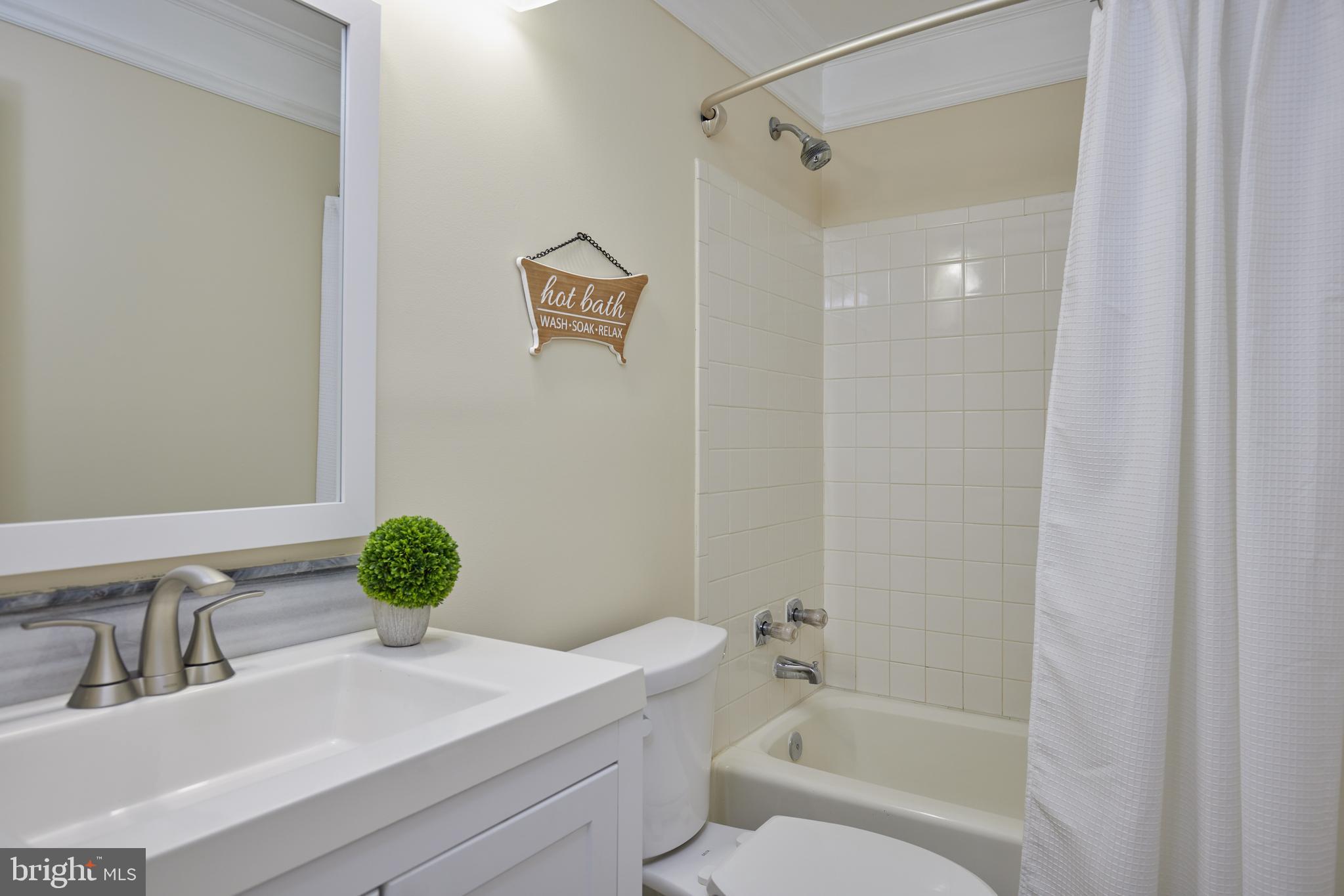 20100 Loading Rock Place Gaithersburg, MD 20886 - Photo 29 of 44 a bathroom with a granite countertop sink a toilet and shower