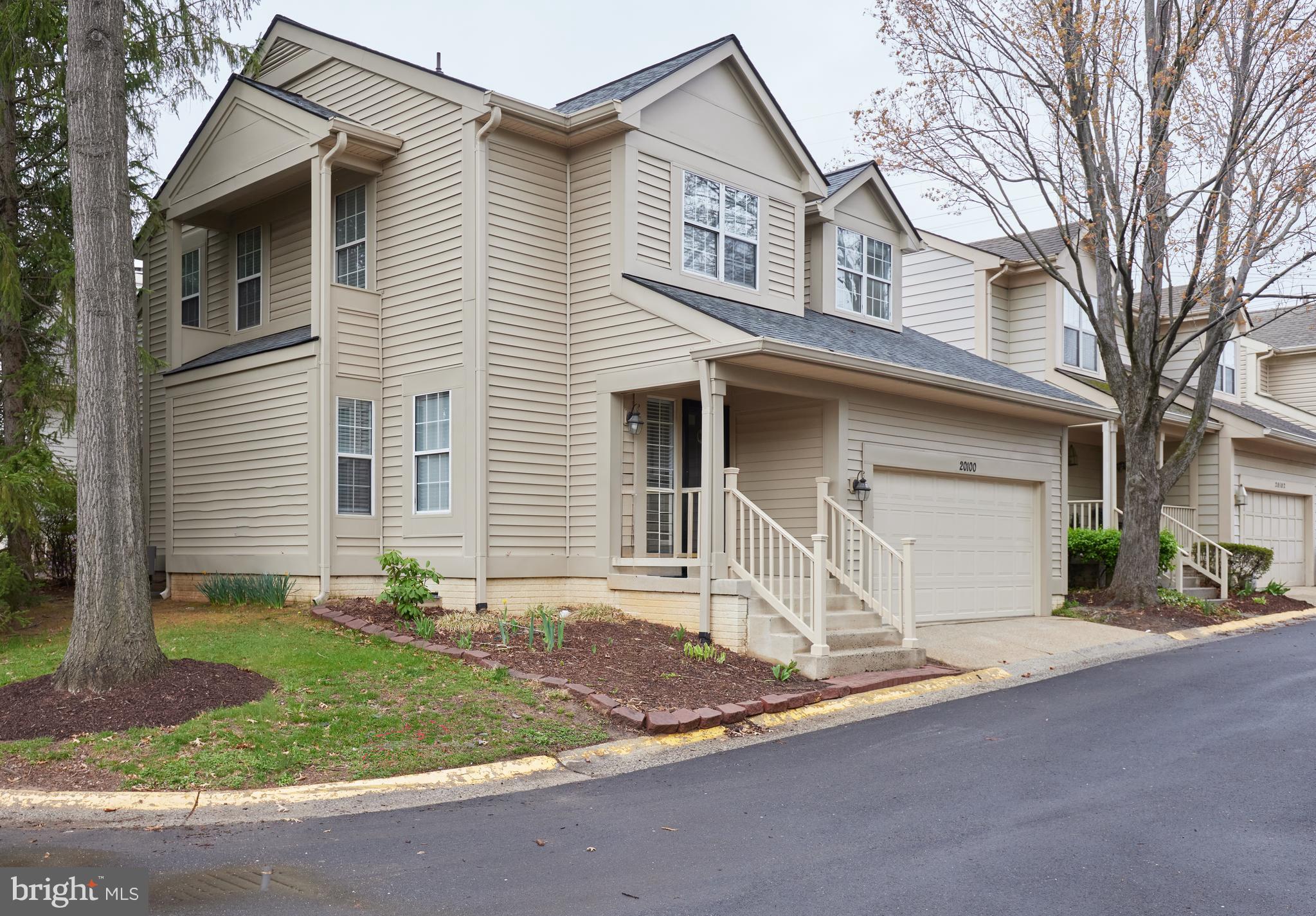 20100 Loading Rock Place Gaithersburg, MD 20886 - Photo 3 of 44 a front view of a house with a yard and garage