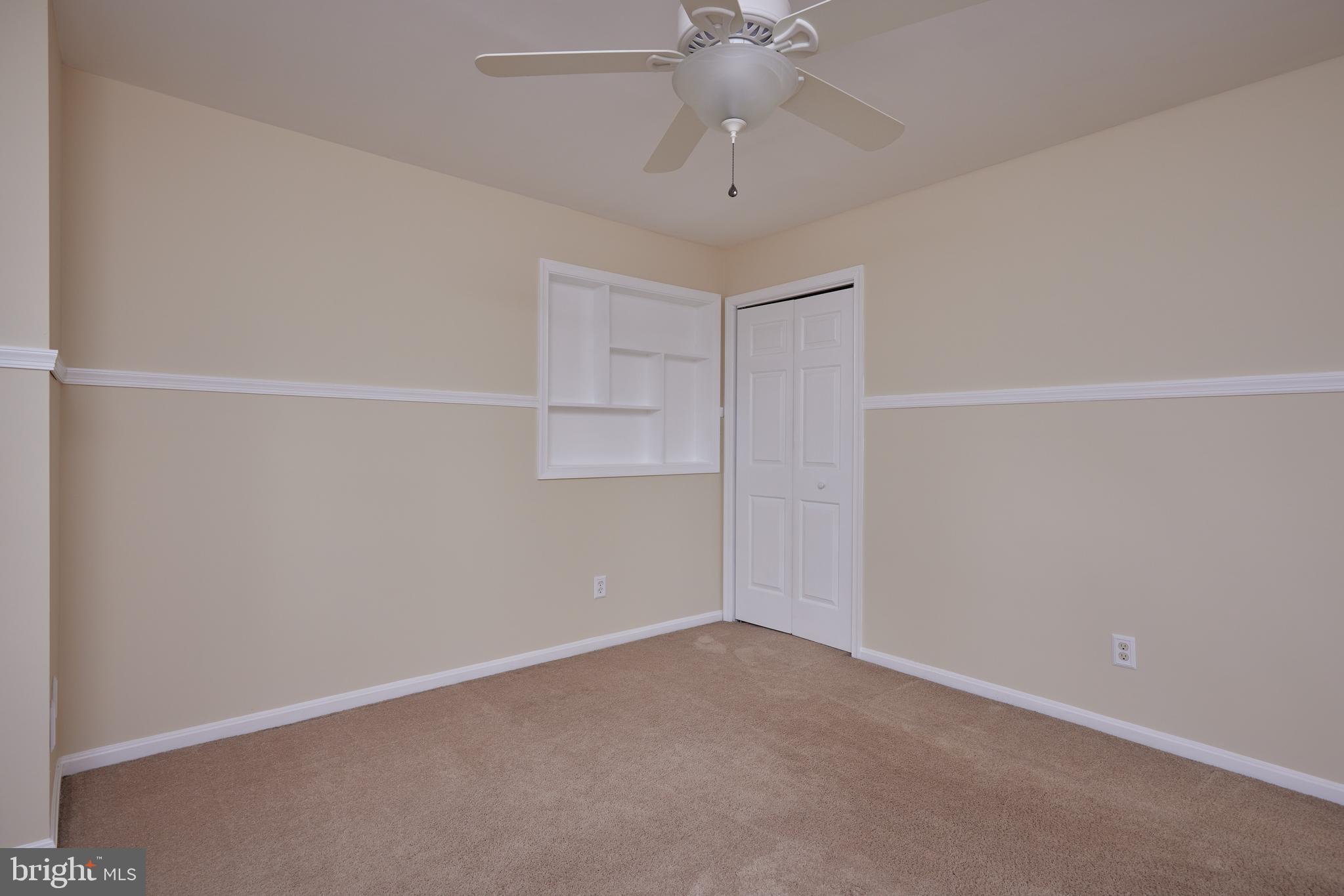 20100 Loading Rock Place Gaithersburg, MD 20886 - Photo 31 of 44 an empty room with a chandelier fan