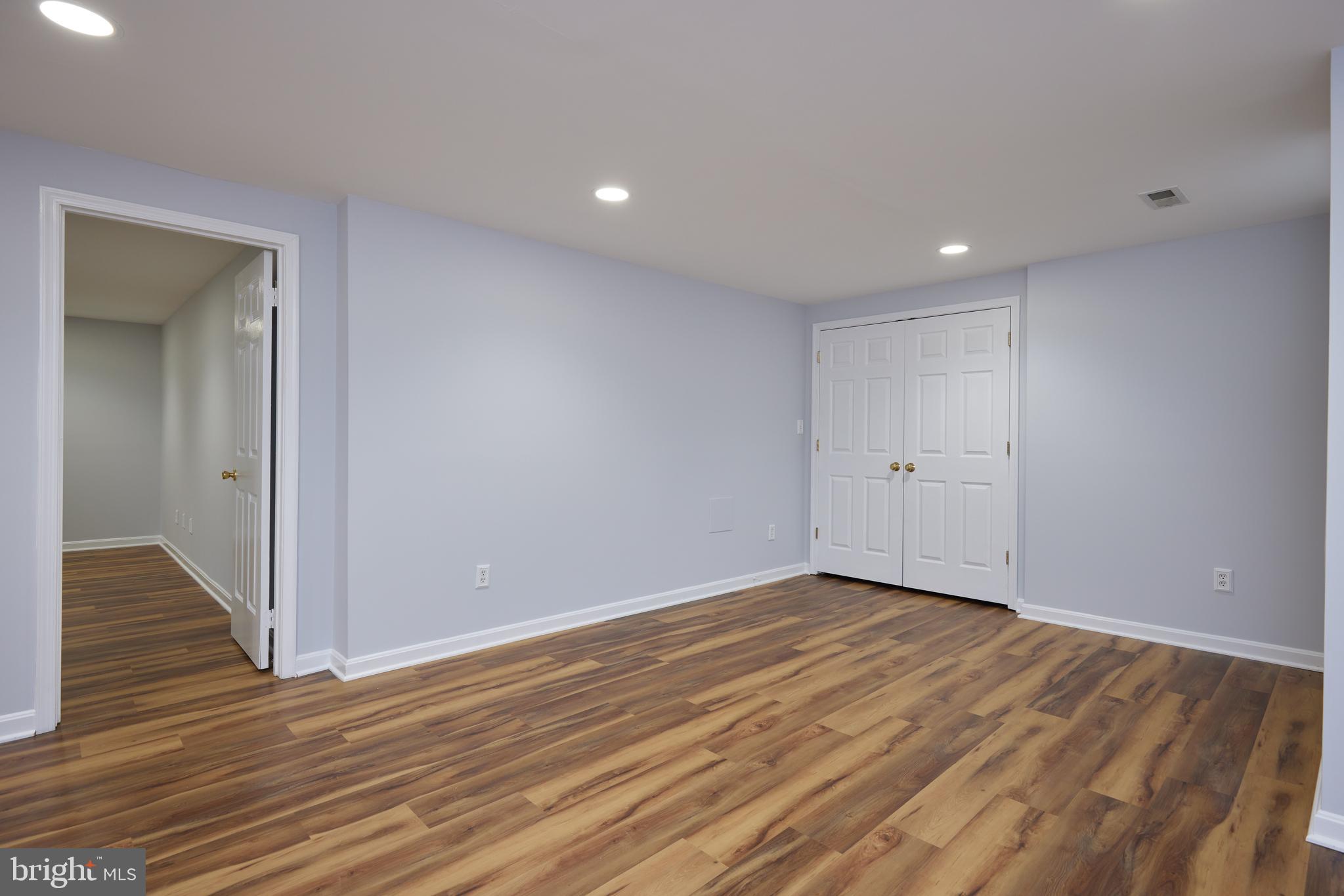 20100 Loading Rock Place Gaithersburg, MD 20886 - Photo 33 of 44 a view of an empty room with wooden floor and closet