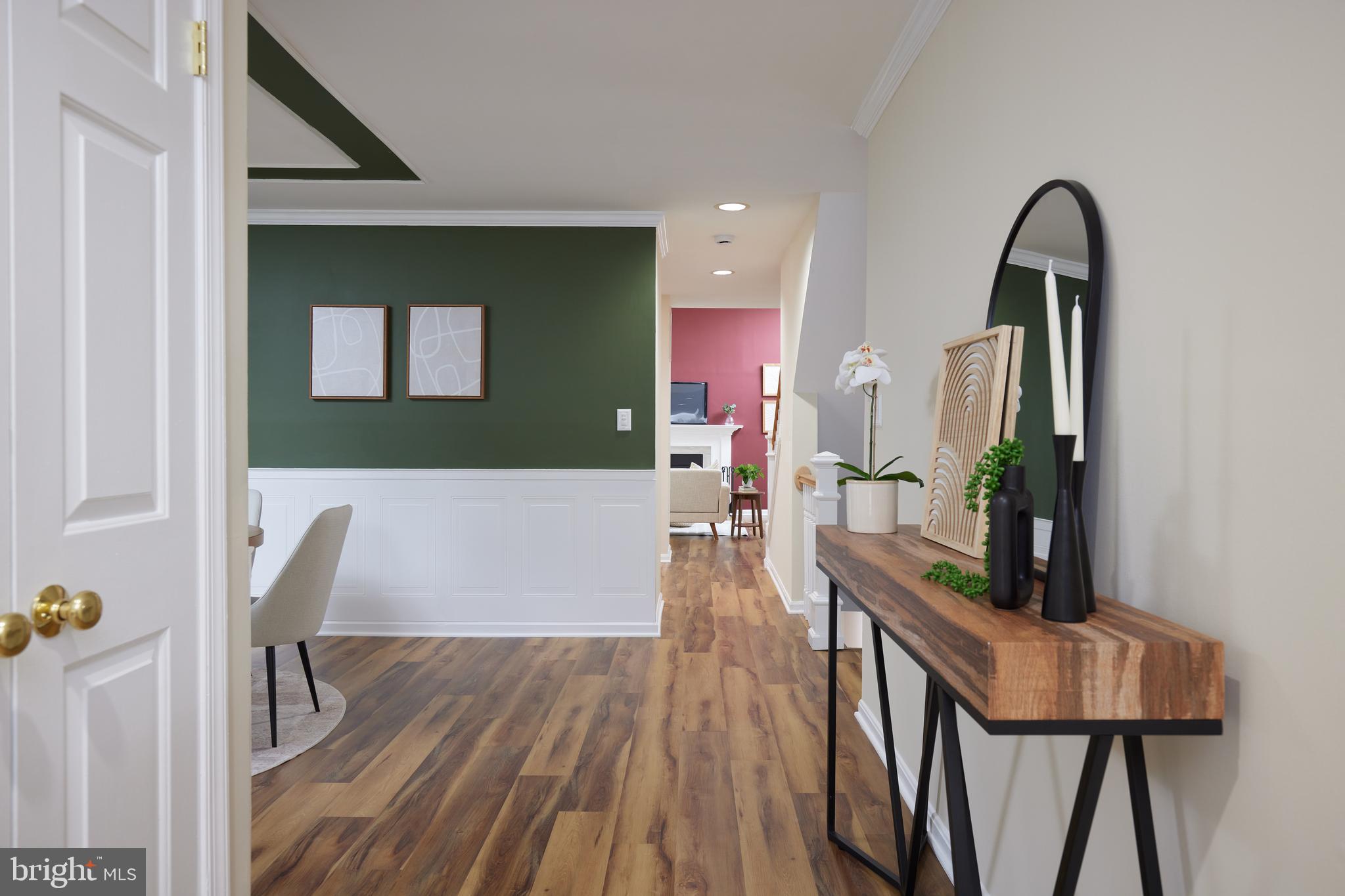 20100 Loading Rock Place Gaithersburg, MD 20886 - Photo 4 of 44 a view of a hallway with wooden floor and furniture