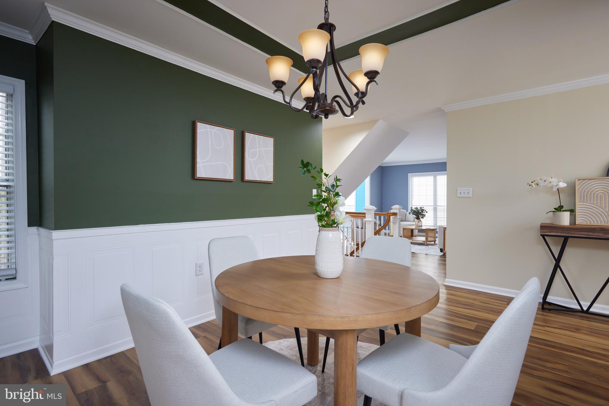 20100 Loading Rock Place Gaithersburg, MD 20886 - Photo 7 of 44 a view of a dining room with furniture and a chandelier