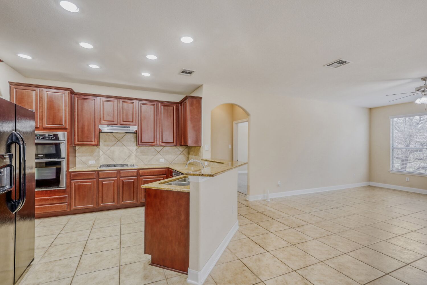 24 Stone Terrace Drive Austin, TX 78734 - Photo 6 of 32 a kitchen with stainless steel appliances granite countertop a stove a sink and a refrigerator