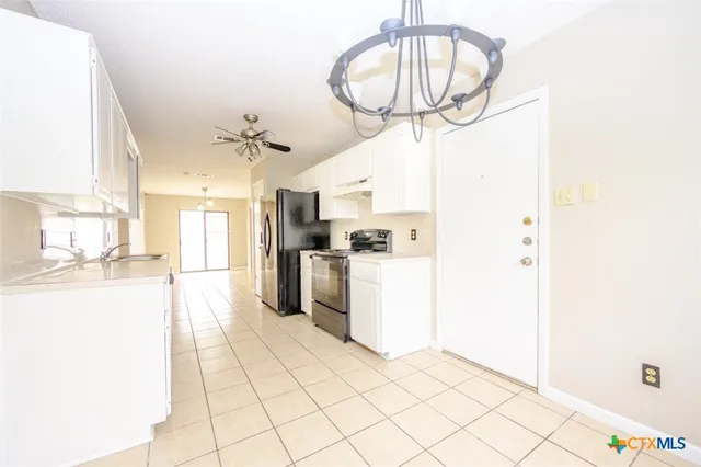 a kitchen with cabinets and stainless steel appliances